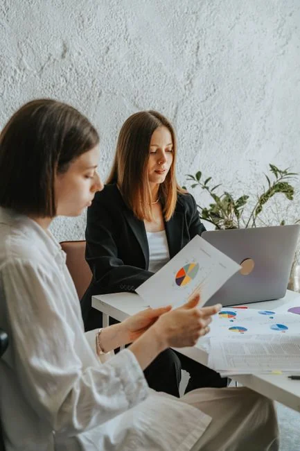 Business professionals collaborating on financial data analysis in a modern office setting.